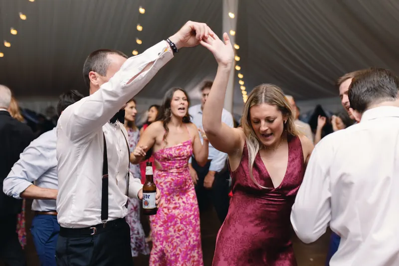 Guests dancing under a tent on a rented dance floor