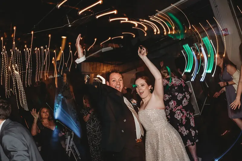 Couple dancing under string lights